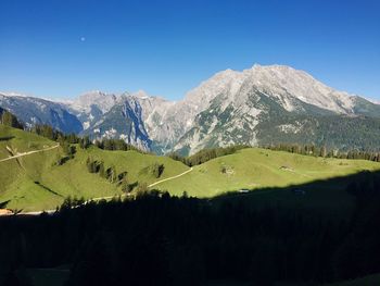 Scenic view of mountains against clear blue sky