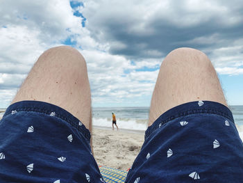 People on beach against sky