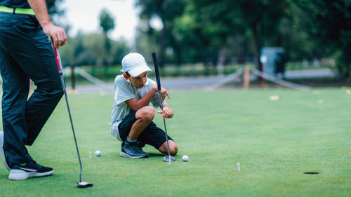 Man playing with ball on grassland