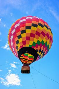 Low angle view of hot air balloon against blue sky