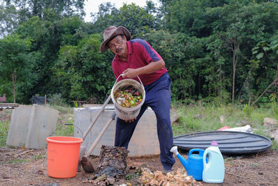 Man holding umbrella while standing on land