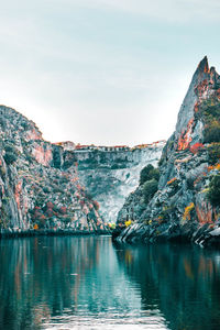 Scenic view of lake and mountains against sky