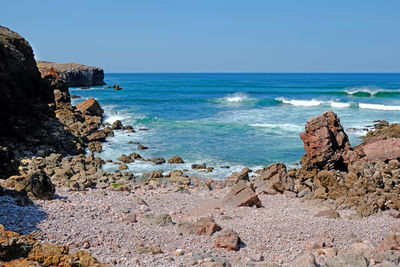 Scenic view of sea against clear blue sky