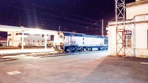 Train on railroad station platform at night