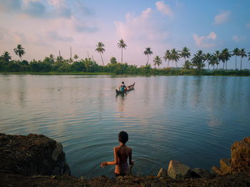 A kid bathing in the lake.