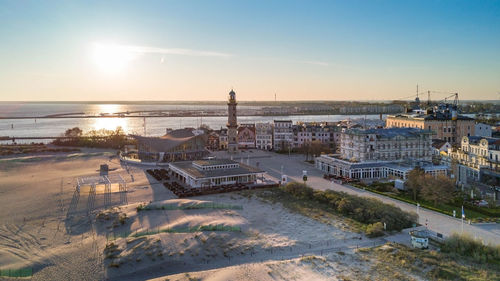 High angle view of buildings by beach against sky