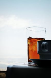 Close-up of beer in water against sky