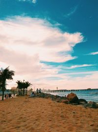 People on beach against sky