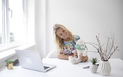 Young woman using laptop at home