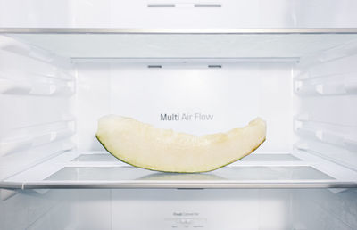 Melon slice inside an empty fridge