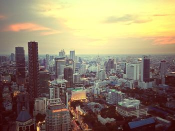 View of cityscape against cloudy sky