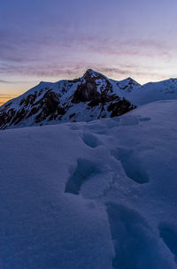 Scenic view of snow covered mountains against sky