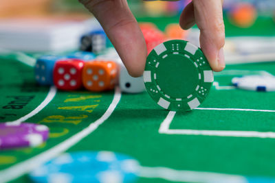 Close-up of hands playing with ball on table