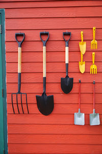 Farm equipment on red wall 