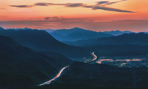 Scenic view of mountains against sky at sunset