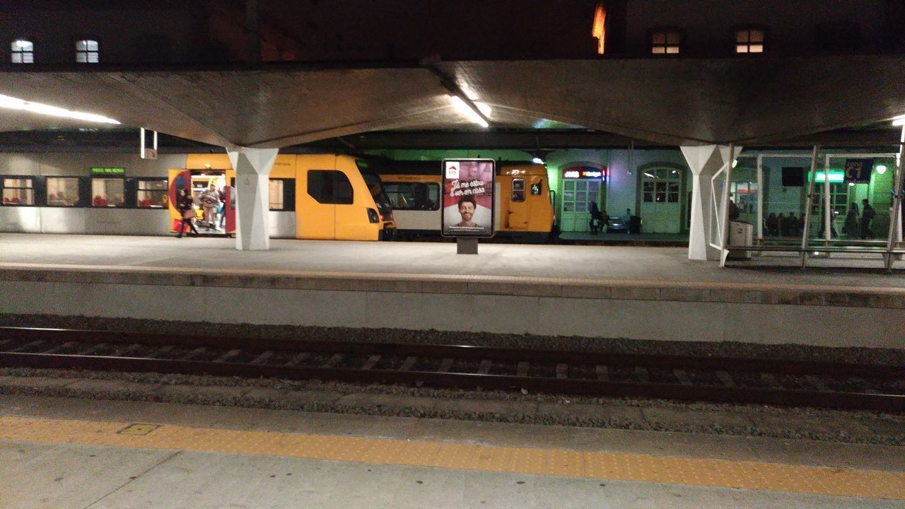 ILLUMINATED RAILROAD STATION PLATFORM AT TRAIN