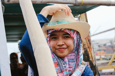 Portrait of young woman wearing hat