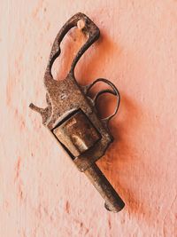 Close-up of rusty gun on wall