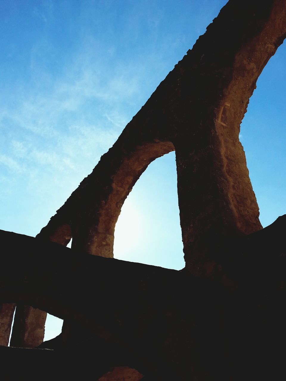 low angle view, built structure, architecture, sky, old, damaged, weathered, arch, old ruin, history, abandoned, blue, obsolete, deterioration, ruined, the past, clear sky, run-down, no people, day