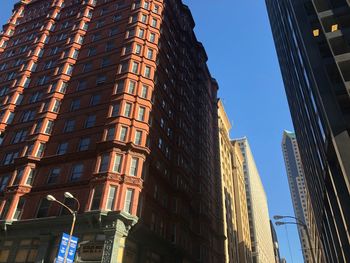 Low angle view of skyscrapers against clear sky