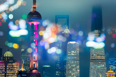 Illuminated buildings in city at night