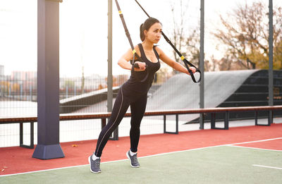 Full length of woman exercising at park