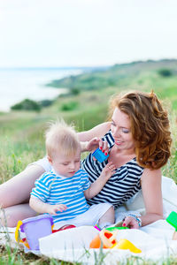 Siblings sitting on land