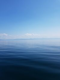 Scenic view of sea against blue sky