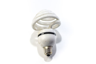 Close-up of light bulb against white background