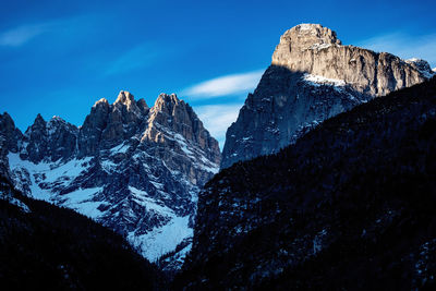 Scenic view of snowcapped mountain against blue sky