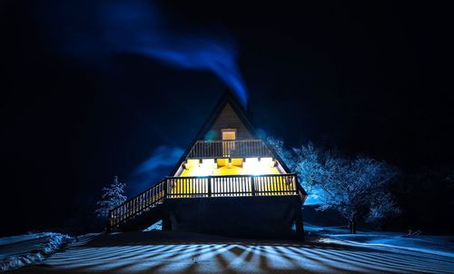 Illuminated built structure in winter at night