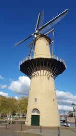 Low angle view of traditional windmill against sky