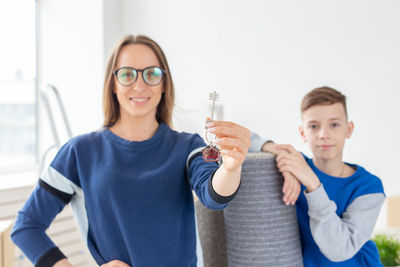 Portrait of smiling boy holding camera