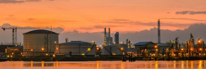 Buildings in city at sunset