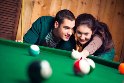 Young couple playing with ball at home