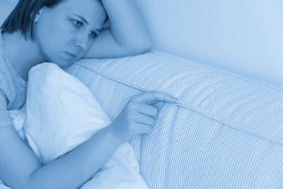 Young woman sleeping on bed at home