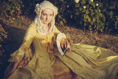 Portrait of a young woman sitting outdoors