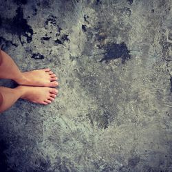 Low section of woman standing on concrete