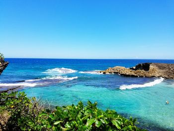 Scenic view of seascape against clear blue sky