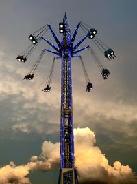 Low angle view of chain swing ride against cloudy sky