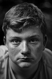 Close-up portrait of teenage boy with freckles