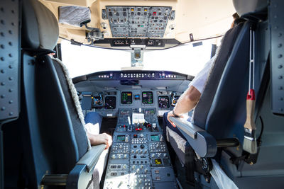 Rear view of pilots in cockpit
