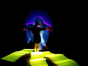 People walking in illuminated stairs at night