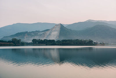 Scenic view of lake with mountain range in background