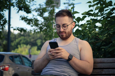 Young man using mobile phone outdoors