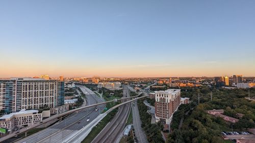 High angle view of cityscape against clear sky during sunset