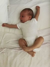 Cute baby lying on bed at home