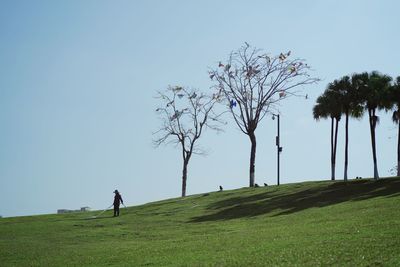 Man on field against clear sky