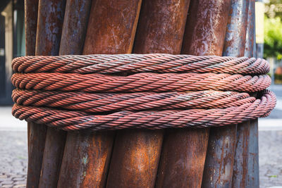 Close-up of rusty metallic rods tied with rope