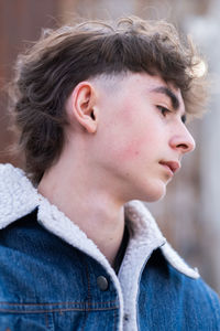 Low angle portrait of handsome young boy looking away